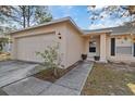 Exterior view of house with attached garage and walkway leading to front door at 12575 Maleo Rd, Weeki Wachee, FL 34614