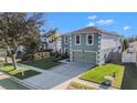 Two-story house, green exterior, two-car garage, and driveway; aerial view at 12739 Kings Lake Dr, Gibsonton, FL 33534