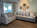 Spacious living room with large sectional sofa and wood floors at 1644 Connecticut Ne Ave, St Petersburg, FL 33703