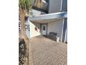 Condominium building entrance with a covered walkway and bench at 18325 Gulf Blvd # 407, Redington Shores, FL 33708