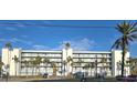 Condominium building exterior, featuring a light-blue facade and palm trees at 18325 Gulf Blvd # 407, Redington Shores, FL 33708