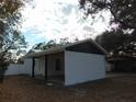 Newly renovated home with carport and white exterior at 214 W 109Th Ave, Tampa, FL 33612