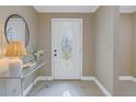 Bright entryway with glass-paned door and console table at 2267 Heron Cir, Clearwater, FL 33762