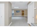 Spacious hallway with tile floors and view of kitchen at 2267 Heron Cir, Clearwater, FL 33762