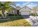 Spacious house with stone exterior and palm trees at 3409 77Th E Ct, Palmetto, FL 34221