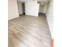 Spacious living area showcasing light gray vinyl plank flooring at 4605 Irene Loop, New Port Richey, FL 34652