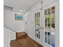 Bright entryway with hardwood floors, French doors, and staircase at 514 Wideview Ave, Tarpon Springs, FL 34689