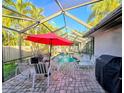 Screened pool and patio area with lounge chairs and grill at 524 Suwanee Cir, Tampa, FL 33606