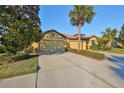House exterior showcasing a two-car garage and manicured landscaping at 5608 Sunset Falls Dr, Apollo Beach, FL 33572