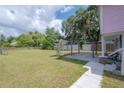 Large grassy backyard with a patio and pergola at 5901 N Cherokee Ave, Tampa, FL 33604