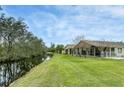 Landscaped backyard with canal view and screened porch at 7538 Berna Ln, Land O Lakes, FL 34637