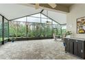 Spacious screened porch with brick flooring and outdoor furniture at 7538 Berna Ln, Land O Lakes, FL 34637