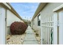 Sidewalk between two houses with landscaping and gate at 7538 Berna Ln, Land O Lakes, FL 34637
