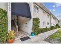 Condo building exterior with landscaped grounds, showcasing a welcoming entrance at 8829 Bay Pointe Dr # 205, Tampa, FL 33615