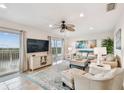Spacious living room with water views, comfortable furniture, and large TV at 8829 Bay Pointe Dr # 205, Tampa, FL 33615