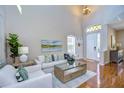 Bright living room with hardwood floors, white sofas, and a large window at 1005 Ketzal Dr, Trinity, FL 34655