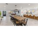Open concept dining room with large wooden table and pool table at 1217 De Narvaez Ave, Bradenton, FL 34209