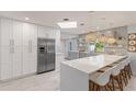 Modern kitchen with white and gray cabinets and a large island at 1217 De Narvaez Ave, Bradenton, FL 34209