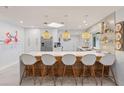 Modern kitchen with white cabinets, quartz countertops, and breakfast bar at 1217 De Narvaez Ave, Bradenton, FL 34209