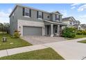 Two-story house with gray siding, stone accents, and landscaping at 18079 Ramble On Way, Land O Lakes, FL 34638