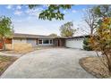 Mid-century modern home with a two-car garage and manicured lawn at 1824 Southwood Ln, Clearwater, FL 33764