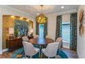 Elegant dining room featuring a round table and stylish light fixture at 18437 Purple Creek Ln, Lutz, FL 33549