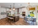 Modern kitchen with large island, stainless steel appliances, and stylish backsplash at 18437 Purple Creek Ln, Lutz, FL 33549