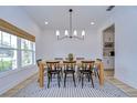 Dining room with light walls, hardwood floors, and a modern chandelier at 22223 Woodmen Hall Dr, Land O Lakes, FL 34637