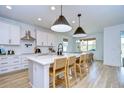 Modern kitchen with white cabinets, marble countertops, and island at 22223 Woodmen Hall Dr, Land O Lakes, FL 34637