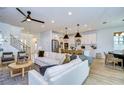 Open concept living room with white couch and a large window at 22223 Woodmen Hall Dr, Land O Lakes, FL 34637