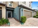 Townhome entry with black door and brick walkway at 28523 Pleasant Bay Loop, Wesley Chapel, FL 33543
