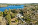 House nestled in lush greenery near a lake at 31445 Amberlea Rd, Dade City, FL 33523