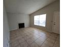 Living room with tile floors, fireplace, and large window at 4031 Tumble Wood Trl # 203, Tampa, FL 33613