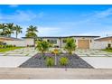 Beautiful modern home with a unique driveway design, lush landscaping and updated exterior at 407 41St Ave, St Pete Beach, FL 33706