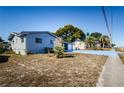 Side view of a ranch style home with a large yard at 4573 Deltona Blvd, Spring Hill, FL 34606