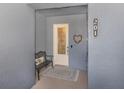 Inviting condo entry with a bench and decorative heart at 507 Tamiami N Trl # 201, Venice, FL 34285