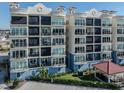Condo building showcasing multiple balconies and water access at 507 Tamiami N Trl # 201, Venice, FL 34285