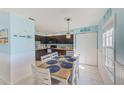 Bright kitchen with dark cabinetry and a dining area at 5116 Beach Se Dr # D, St Petersburg, FL 33705