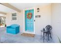 Inviting teal front door with a fall wreath and welcoming doormat at 6350 22Nd N Ave, St Petersburg, FL 33710