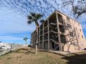 Condo building with waterfront view and palm trees at 12500 Capri Cir N # 302, Treasure Island, FL 33706