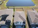 Aerial view showcasing a house's backyard and a lake at 16719 Delia St, Wimauma, FL 33598