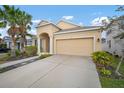 Well maintained house with a two-car garage and a walkway to the front door at 211 Shell Creek Ct, Apollo Beach, FL 33572