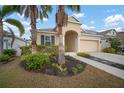 Attractive house with a landscaped yard, palm trees and a two-car garage at 211 Shell Creek Ct, Apollo Beach, FL 33572