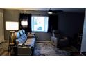 Living area featuring a gray reclining sofa and armchair at 22481 Westchester Blvd # A23, Punta Gorda, FL 33980