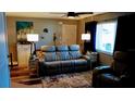 Living room with recliner sofa and floor lamp at 22481 Westchester Blvd # A23, Punta Gorda, FL 33980