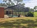 Relaxing screened-in pool area with lush tropical landscaping at 2280 Toniwood Ln, Palm Harbor, FL 34685