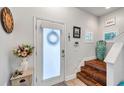 Front entry with frosted glass door and wooden staircase at 2602 W Nassau St, Tampa, FL 33607