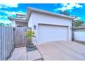 White garage door and wooden fence at 2602 W Nassau St, Tampa, FL 33607