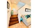 Wooden staircase and sitting area with sectional sofa at 2602 W Nassau St, Tampa, FL 33607