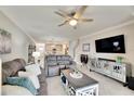 Spacious living room with gray sectional sofa and large TV at 31428 Briars Ml, San Antonio, FL 33576